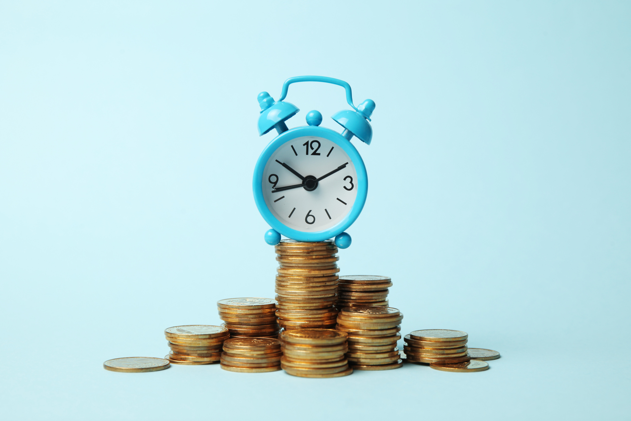Finance investment, Time is money. Alarm clock and golden money coins, pension